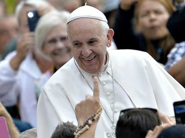 Pope Francis greets the crowd as he arrives for his weekly general audience at St Peter's square on September 30, 2015 at the Vatican. AFP PHOTO / ANDREAS SOLARO (Photo credit should read