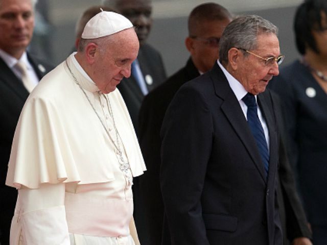 Pope Francis walks with Cuba's President Raul Castro (R) as he arrives at Jose Marti