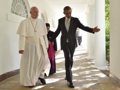 Barack Obama and Pope Francis walk through the Colonnade on their way to a bilateral meeti