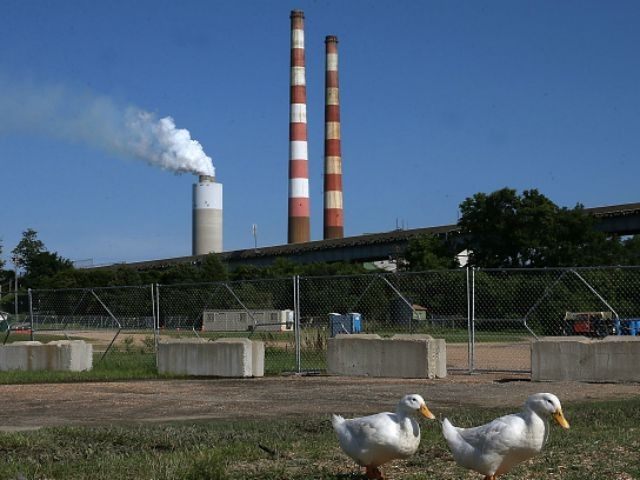 Two white ducks walk along the Beach at Aqualand Marina as emissions spew out of a large stack nearby at the coal-fired Morgantown Generating Station on the Potomac River on June 29, 2015 in Newburg, Maryland. Today the U.S. Supreme Court ruled against the Environmental Protection Agency's (EPA) effort to …