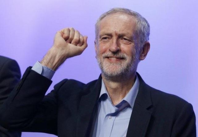 The new leader of Britain's opposition Labour Party Jeremy Corbyn gestures as he aknowledg