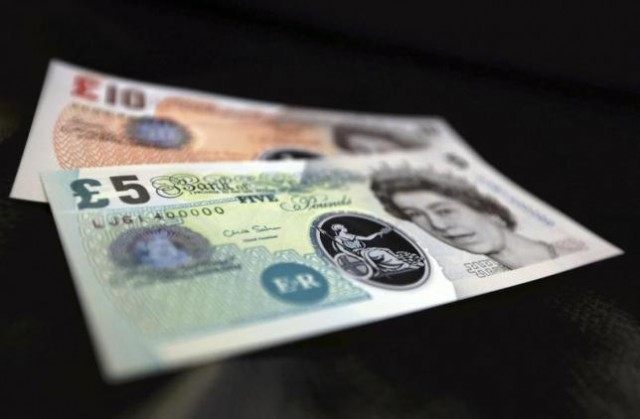 Sample polymer five and ten GB pound banknotes are seen on display at the Bank of England