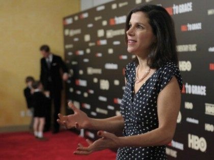 Filmmaker Alexandra Pelosi is interviewed while her husband Michiel Vos and sons Paul Vos and Thomas Vos stand in the background during the New York premiere of the HBO documentary Fall to Grace at Time Warner Center Screening Room on March 21, 2013 in New York City.