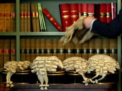 LONDON - MAY 7: A Barrister picks up his wig prior to British Home Secretary David Blunkett announcing changes to sentencing laws May 7, 2003 in London, England.