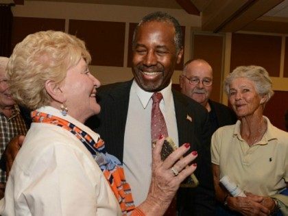 Republican presidential candidate Ben Carson speaks with supporters following a town hall
