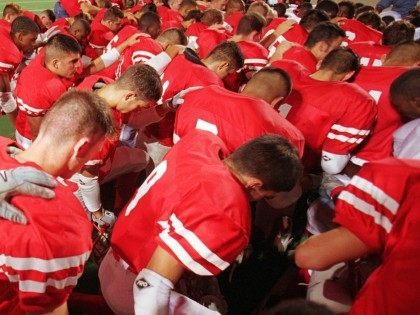 Football prayer (Joe Raedle / Hulton Archive / Getty)