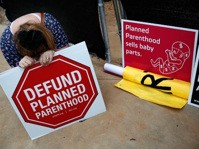 Right to Life advocate Linda Heilman prays during a sit-in in front of a proposed Planned Parenthood location while demonstrating the group's opposition to congressional funding of Planned Parenthood on September 21, 2015 in Washington, DC. The Right to Life groups who took part in the protest are also calling …