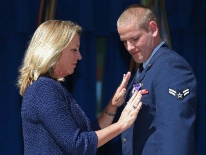 Air Force Airman 1st Class Spencer Stone (R) receives the Purple Heart medal from Secretar