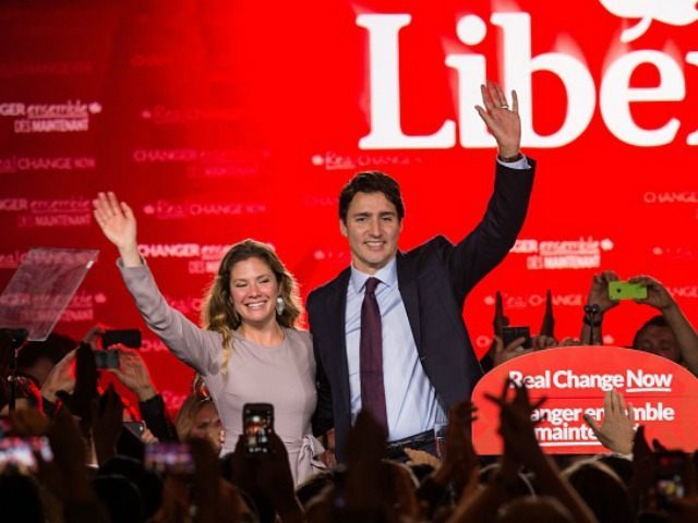 Canadian Liberal Party leader Justin Trudeau and his wife Sophie wave on stage in Montreal