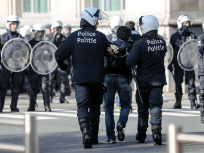 A protester is arrested by police as Afghan refugees came to demonstrate in front of the P