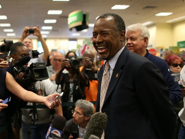 Republican presidential candidate Ben Carson speaks to the media during a stop to sign his