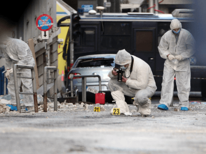 Police forensic experts search for evidence outside the Greece's industry association