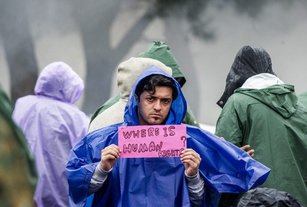 A man holds a placard reading ‘where is human rights’ during a demonstration of migrants waiting to cross the Greek-Macedonian border near Gevgelija, on November 25, 2015. Since last week, Macedonia has restricted passage to northern Europe to only Syrians, Iraqis and Afghans who are considered war refugees. All other nationalities are deemed economic migrants and told to turn back. Over 1,500 people are stuck on the border, mostly Indians, Moroccans, Bangladeshis and Pakistanis.AFP PHOTO / ROBERT ATANASOVSKI / AFP / ROBERT ATANASOVSKI (Photo credit should read ROBERT ATANASOVSKI/AFP/Getty Images)