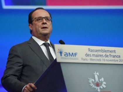 Francois Hollande delivers a speech during a meeting of French mayors in Paris on November