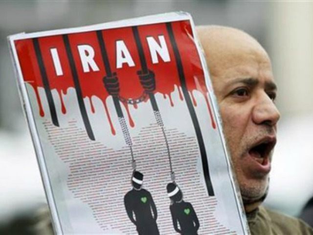 An Iranian exile shouts slogans to protest against executions in Iran during a demonstration in front of the Iranian embassy in Brussels, December 29, 2010. (Francois Lenoir/Reuters)