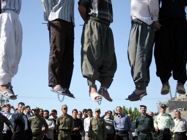 Iranian police officers and others view the scene as five convicted criminals are hung, in a neighborhood of Mashad, 1,000 kilometers (620 miles) northwest of Tehran, Iran, on Wednesday Aug. 1, 2007. In the second round of collective executions in ten days, Iran on Wednesday publicly hanged 7 criminals convicted …