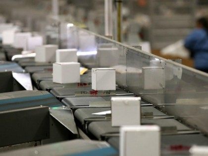 Packages move along a conveyor belt at the U.S. Post Office sort center on December 18, 20