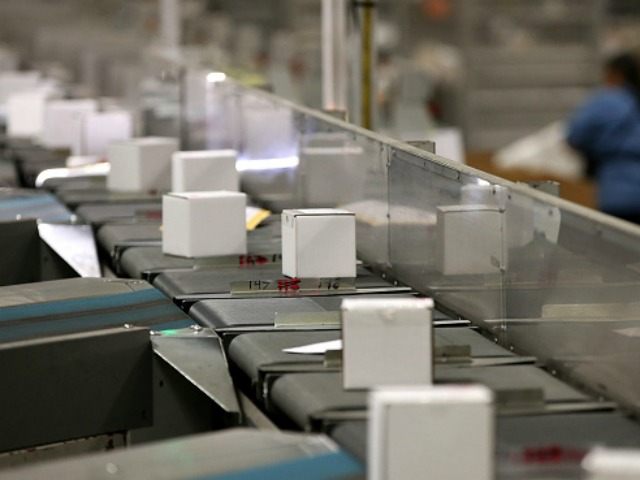 Packages move along a conveyor belt at the U.S. Post Office sort center on December 18, 20