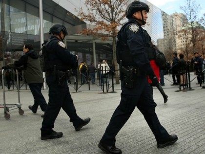 New York City police officers walk near One World Trade Center in lower Manhattan on November 24, 2015 in New York City. Following the terrorist attacks in Paris, security in New York City has been heightened throughout the metropolitan area as experts try to determine the nature of threats from …