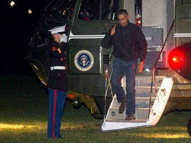 President Barack Obama salutes as he walks off Marine One after landing on the South Lawn