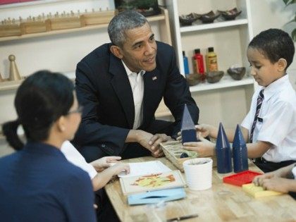 Barack Obama (C) speaks with children between the ages of seven and nine as he tours the D