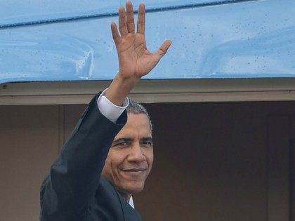 Barack Obama waves as he boards Air Force One for his departure at the Royal Malaysian Air