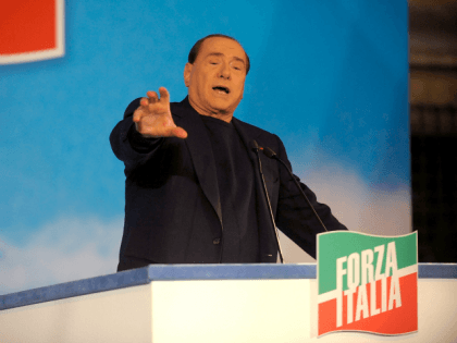ROME, ITALY - NOVEMBER 27: Former Italian Prime Minister Silvio Berlusconi gestures as he attends a rally outside his house, Palazzo Grazioli, on November 27, 2013 in Rome, Italy.