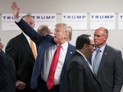 Republican presidential candidate Donald Trump waves to guests as he leaves a rally at Des