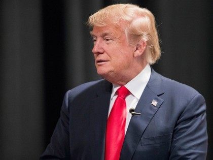 Republican presidential candidate Donald Trump speaks to guests following a town hall meet