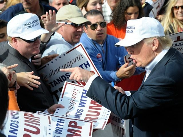 Republican presidential candidate Donald Trump talks with attendees at a rally in front of the USS Wisconsin on October 31, 2015 in Norfolk, Virginia. . With just 93 days before the Iowa caucuses Republican hopefuls are trying to shore up support amongst the party. (Photo by
