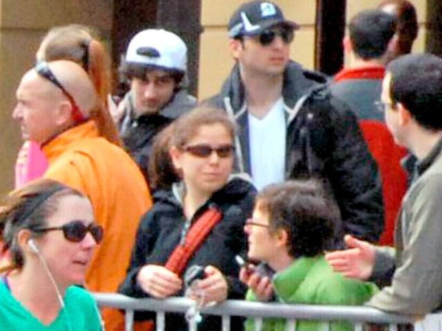 FILE - This Monday, April 15, 2013 file photo provided by Bob Leonard shows second from right, Tamerlan Tsarnaev, who was dubbed Suspect No. 1 and third from right, Dzhokhar A. Tsarnaev, who was dubbed Suspect No. 2 in the Boston Marathon bombings by law enforcement. This image was taken approximately 10-20 minutes before the blast. Since Monday, Boston has experienced five days of fear, beginning with the marathon bombing attack, an intense manhunt and much uncertainty ending in the death of one suspect and the capture of the other. (AP Photo/Bob Leonard, File)
