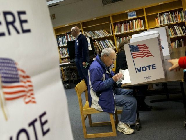 Steve Maskell of McLean, Va., right, votes on election day in McLean, Va., Tuesday, Nov. 5