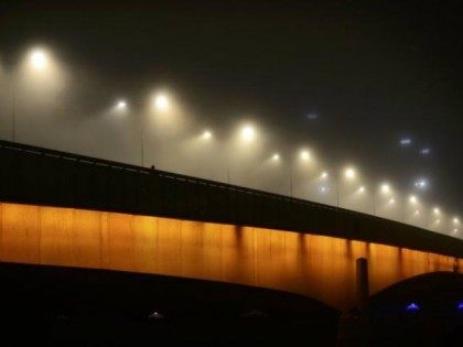 Fog shrouds London Bridge as a man takes a late …