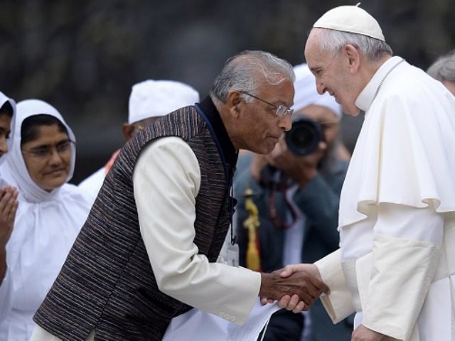 Pope Francis (R) greets people of different religions at the end a weekly general audience