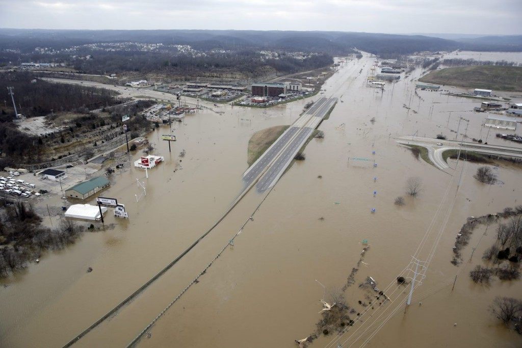 In this aerial photo, flood water covers Interstate 44, Wednesday, Dec 30, 2015, in Valley Park, Mo. A rare winter flood threatened nearly two dozen federal levees in Missouri and Illinois on Wednesday as rivers rose, prompting evacuations in several places. (AP Photo/Jeff Roberson)