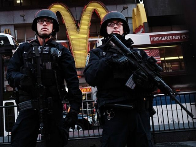 New York police officers with high powered rifles patrol in Times Square on December 7, 20