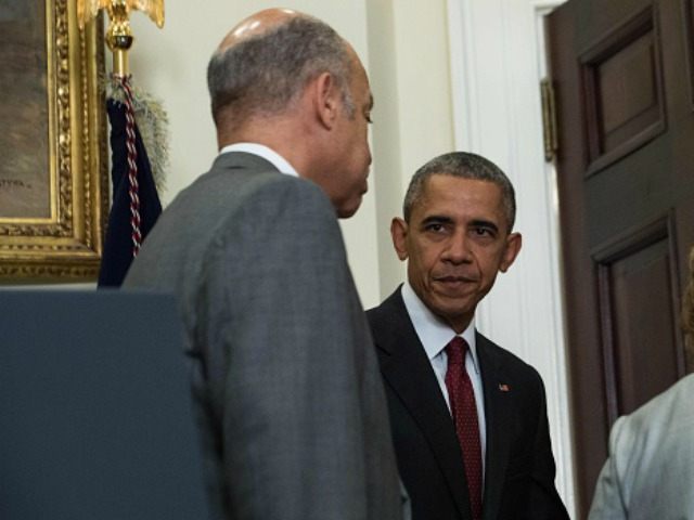 Barack Obama holds the door for Homeland Security Secretary Jeh Johnson (L) after making a