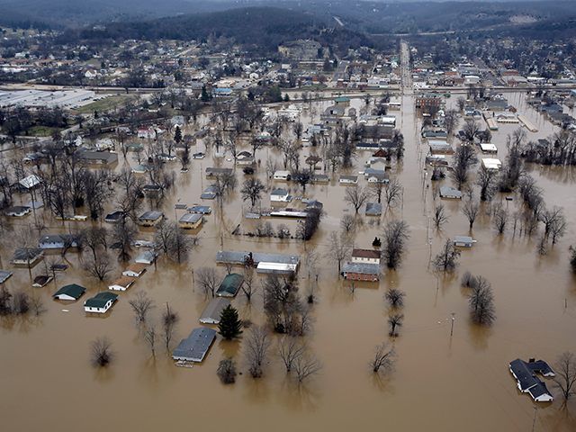 In this aerial photo, floodwater surrounds homes and businesses, Wednesday, Dec. 30, 2015,