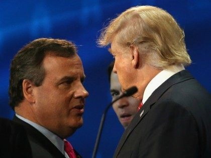 Presidential candidates Donald Trump (R) speaks with New Jersey Gov. Chris Christie during