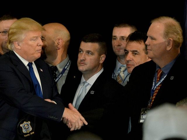 Republican presidential candidate Donald Trump shakes hands with Jerry Flynn, Executive Di