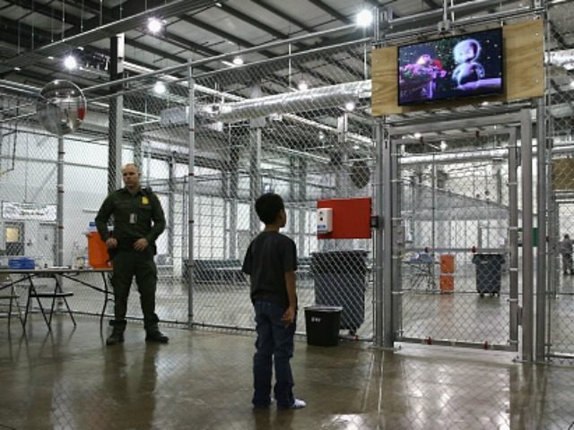 A boy from Honduras watches a movie at a detention facility run by the U.S. Border Patrol