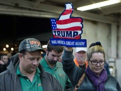Supporters of US Republican presidential candidate Donald Trump listen to the invocation b