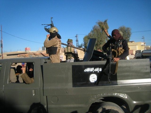FILE - in this Thursday, March 20, 2014 file photo, Islamic State group militants patrol in a commandeered Iraqi security forces trucks sprayed with the representation of the al-Qaida flag and the Arabic that reads, "There is no god but Allah," in Fallujah, 40 miles (65 kilometers) west of Baghdad, …