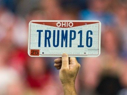 : A supporter holds up a personalized license plate labeled 'Trump16' during a c