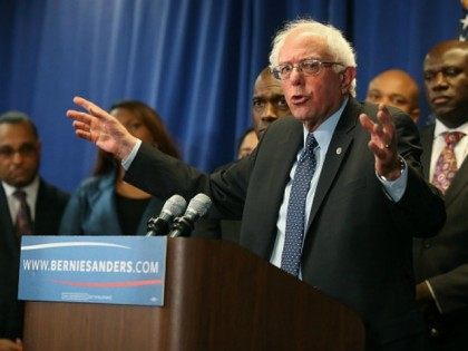 Democratic presidential candidate Sen. Bernie Sanders, (I-VT) speaks while flanked by Afri