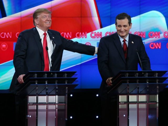 Republican presidential candidate Donald Trump (L) pats U.S. Sen. Ted Cruz (R-TX) after a