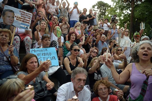 People take part in a vigil on the first anniversary of Argentinian prosecutor Alberto Nisman's mysterious death in Buenos Aires, on January 18, 2016. The prosecutor died in mysterious circumstances in January 18, 2015, after accusing Argentina's then president, Cristina Fernandez de Kirchner, of obstructing his investigation of a 1994 bombing at a Buenos Aires Jewish center. AFP PHOTO/EITAN ABRAMOVICH. / AFP / EITAN ABRAMOVICH (Photo credit should read EITAN ABRAMOVICH/AFP/Getty Images)
