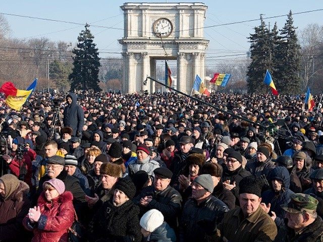 People attend the rally in front of the Parliament building in Chisinau on January 21, 201