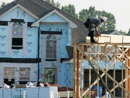 Construction workers build a new home Tuesday, Aug. 22, 2006 in Houston. Sales of new home