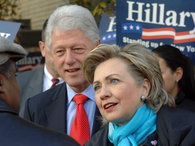 Former President Bill Clinton, center, and Sen. Hillary Rodham Clinton, D-NY, greet commut